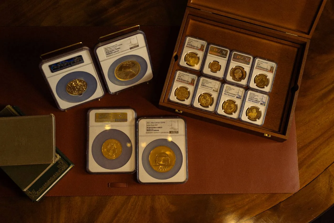 A collection of graded, slabbed gold coins in a presentation case